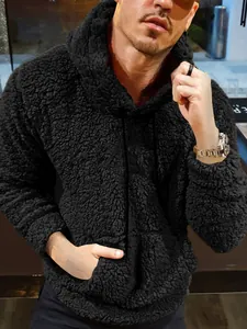 Close-up of men's black teddy fleece hoodie with drawstring and soft texture