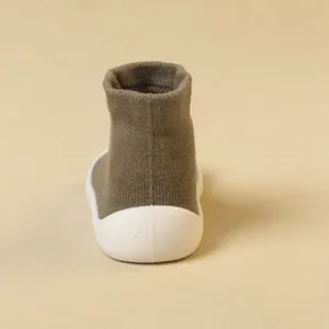 Back view of children's green knit toddler shoes with soft white rubber soles.