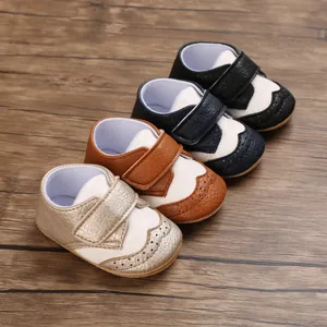 Infant walking shoes in four classic color combinations with decorative perforated details.