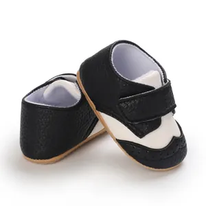 Detail of classic black and white baby walking shoes with anti-slip soft rubber soles
