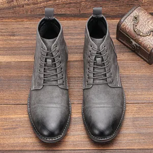 Vista superior de botas Martin grises con textura para hombre sobre fondo de madera rústica