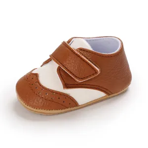 Detail view of brown and white baby walking shoes with velcro strap and anti-slip sole