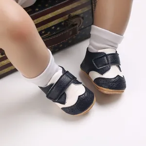 Detailed view of navy blue and white baby walking shoes featuring a secure hook and loop strap