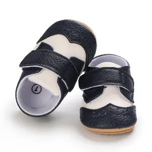 Detailed macro view of navy and white baby walking shoes with classic brogue detailing