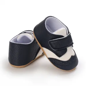 Macro view of black and white leather baby walking shoes with anti-slip rubber soles