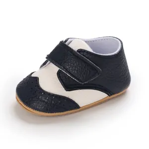Close-up of blue and white baby walking shoe with hook-and-loop closure and wingtip detail