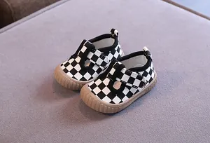 Detail view of checkerboard baby canvas shoes with non-slip soft soles