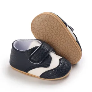Close-up of navy and white baby walking shoes with non-slip textured rubber soles