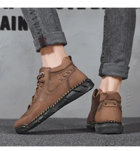 Detailed view of brown men's high-top casual leather boots with textured finish