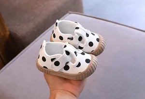 Detailed close-up of baby polka dot walking shoes with soft non-slip rubber soles