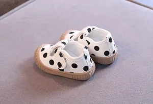 Detailed view of breathable polka dot baby canvas shoes featuring a soft non-slip rubber sole