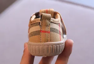 Detailed view of baby canvas shoe heel with classic plaid pattern and soft sole.
