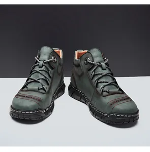 Durable men's high-top work boots in teal leather with distinctive stitched details