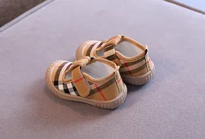 Detailed view of breathable canvas baby walking shoes with classic check pattern