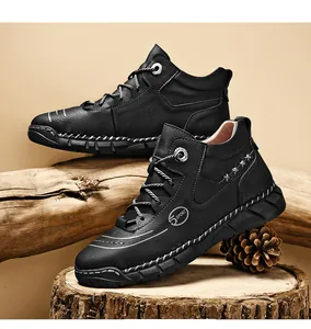 Detailed view of men's black high-top leather work boots featuring contrast white stitching