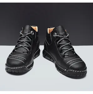 Detailed view of black leather high-top Martin boots with white contrast stitching
