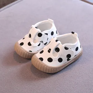 Infant white canvas walking shoes with black polka dots and anti-slip soft rubber soles