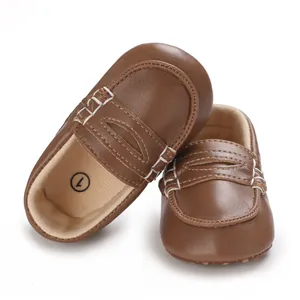 Nahaufnahme brauner PU-Leder-Babyschuhe mit weicher Sohle und weißen Ziernähten