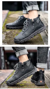 Detailed view of men's black leather mid-top work boots with side zipper and laces.