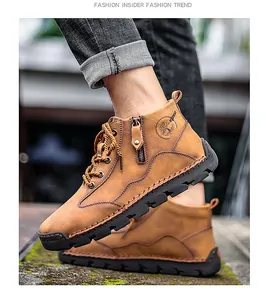 Detailed view of men's brown leather work boots with side zipper and rugged sole