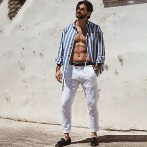 Handsome male model showcasing a blue and white vertical striped casual beach shirt