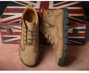 Close-up of men's retro brown leather work boots with side zipper and Union Jack background