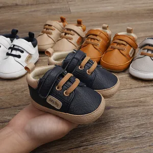 Macro view showing the soft leather texture and stitching of colorful baby walking shoes