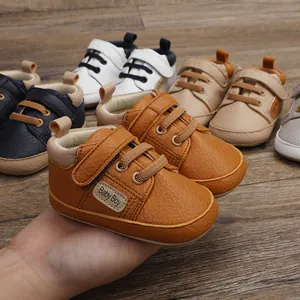 Close-up of brown leather baby walker shoes with Velcro strap and laces