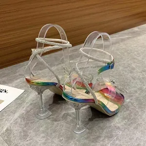 Back view of rainbow iridescent sandals with crystal bow and clear stiletto heel
