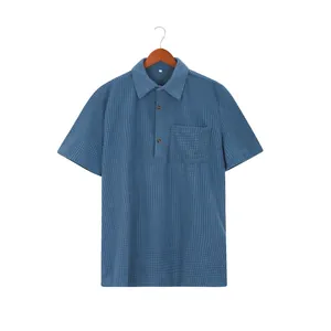 Detailed view of the waffle knit texture on a blue men's short-sleeved polo shirt