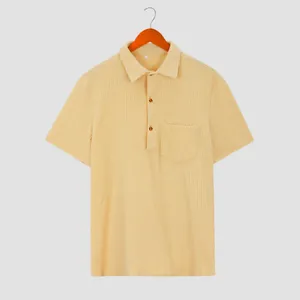 Close-up of beige men's waffle knit short sleeve shirt with buttoned polo collar