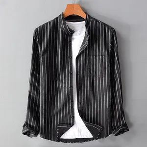 Close-up detail of a men's black vertical striped cotton linen shirt with a stand collar
