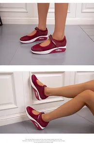 Detail of breathable burgundy mesh wedge sneakers with velcro strap and air cushion
