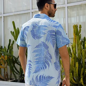 Detailed rear view of a men's light blue summer beach shirt with blue leaf patterns