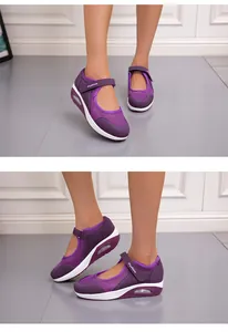 Detailed view of purple mesh Mary Jane sneakers with hook-and-loop straps on feet.