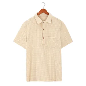 Detail of beige waffle knit short sleeve polo shirt with chest pocket and lapel collar