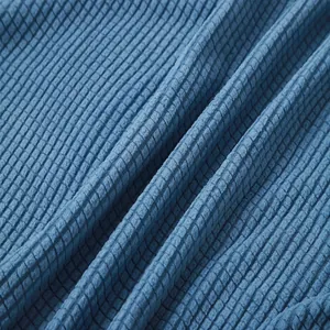 Close-up macro shot of blue waffle-knit fabric texture for minimalist men's summer shirt