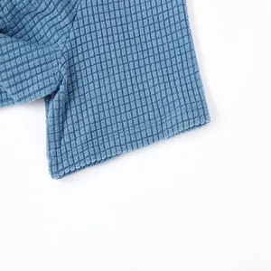High-quality close-up showing the intricate blue waffle knit fabric texture on a men's shirt