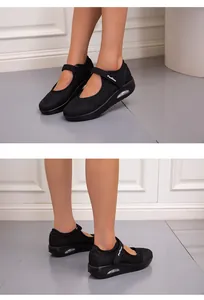 Side view of breathable black mesh women's walking shoes featuring comfortable velcro straps