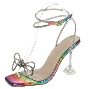 Elegant rainbow rhinestone high heel sandals with sparkling bow detail and clear stiletto heel