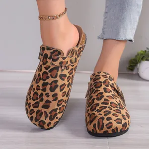Close-up detail view showing the texture of stylish leopard print clogs on model's feet