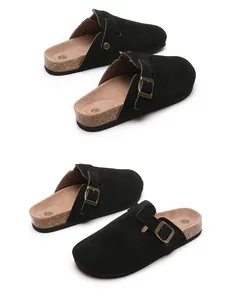 Close-up of black suede clogs with adjustable buckle and cork sole details