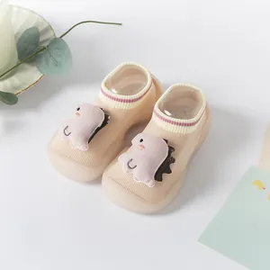 Close-up of cute baby floor socks shoes with 3D dinosaur and non-slip silicone sole