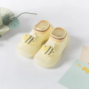 Cute yellow baby walking socks with soft bee motif and anti-slip silicone sole detail