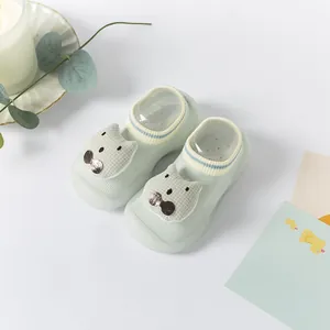 Cute light green baby walking socks shoes featuring a soft silicone sole and cat face detail