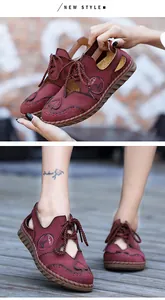 Dettaglio dei sandali retrò in pelle bordeaux con cuciture manuali e design traforato