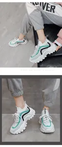 Close-up of stylish women's flyknit chunky sneakers in white and turquoise colorway