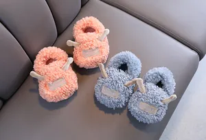 Cozy and cute plush children's indoor slippers in pink and blue with soft fleece texture