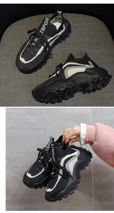 Close-up of black flyknit chunky sneakers with white wave pattern and Sports logo