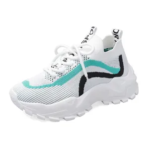 Breathable white fly-knit chunky sneakers with teal and black wave pattern for women